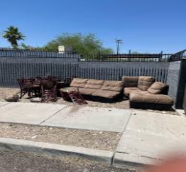 Clutter in front of fence.